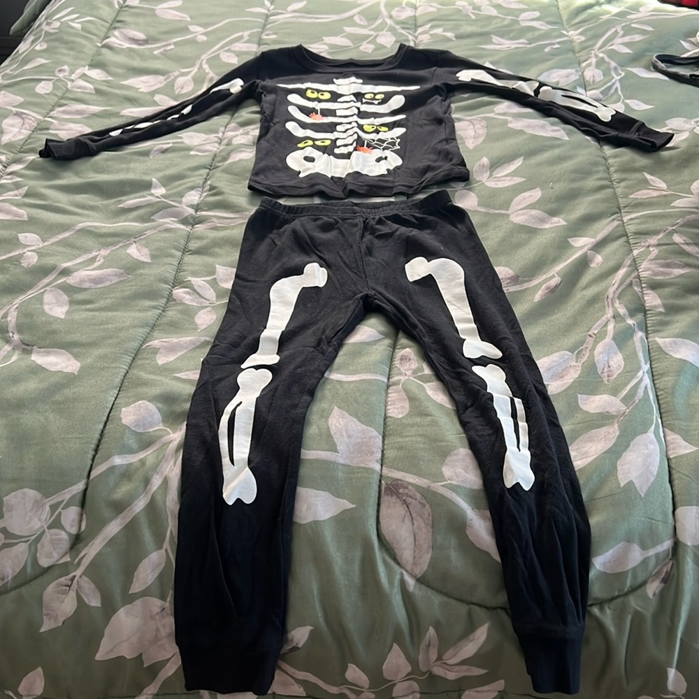 Kids size 5T glow in the dark skeleton pajamas.